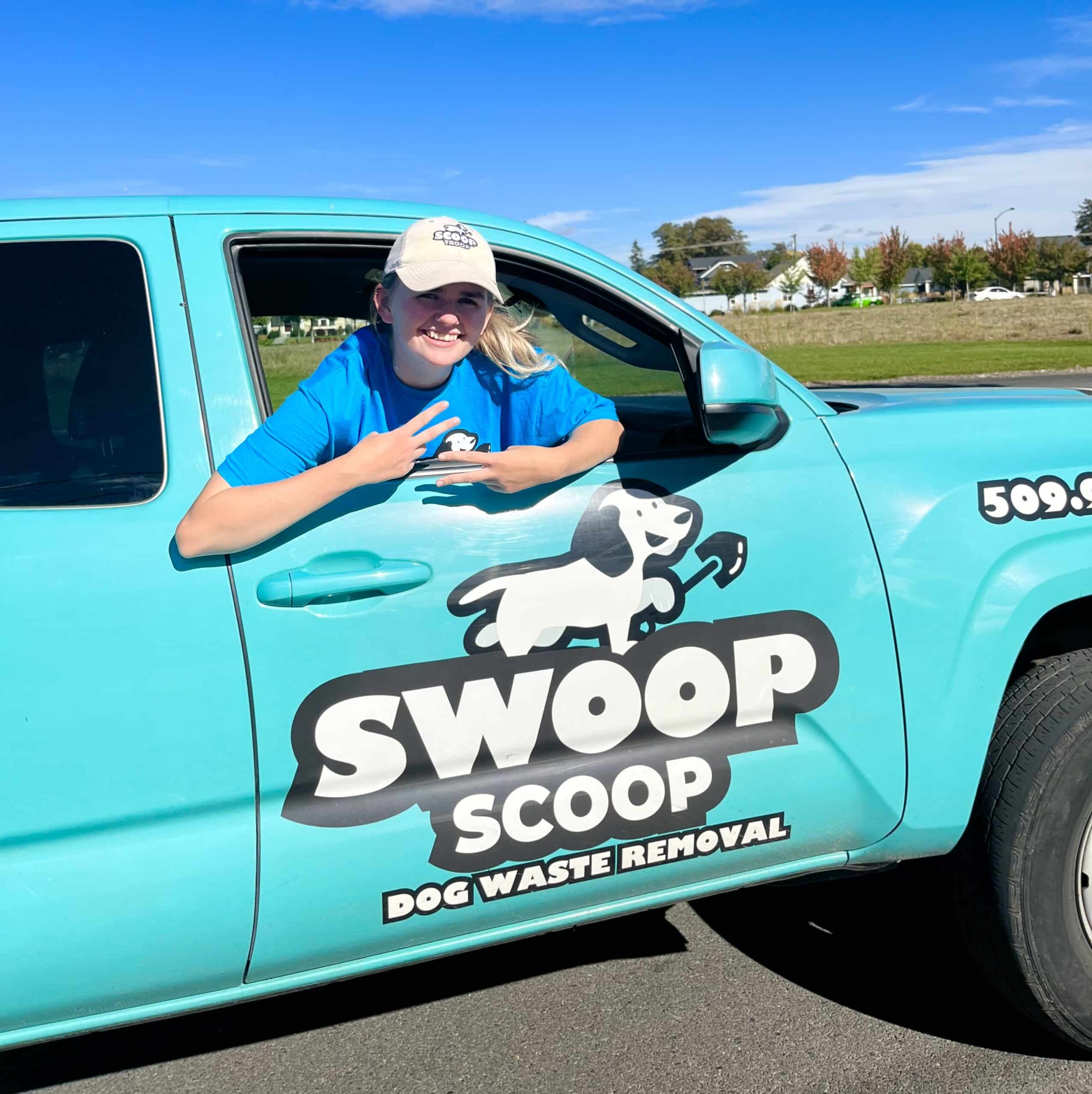 Swoop Scoop employee giving the peace sign out a truck window.