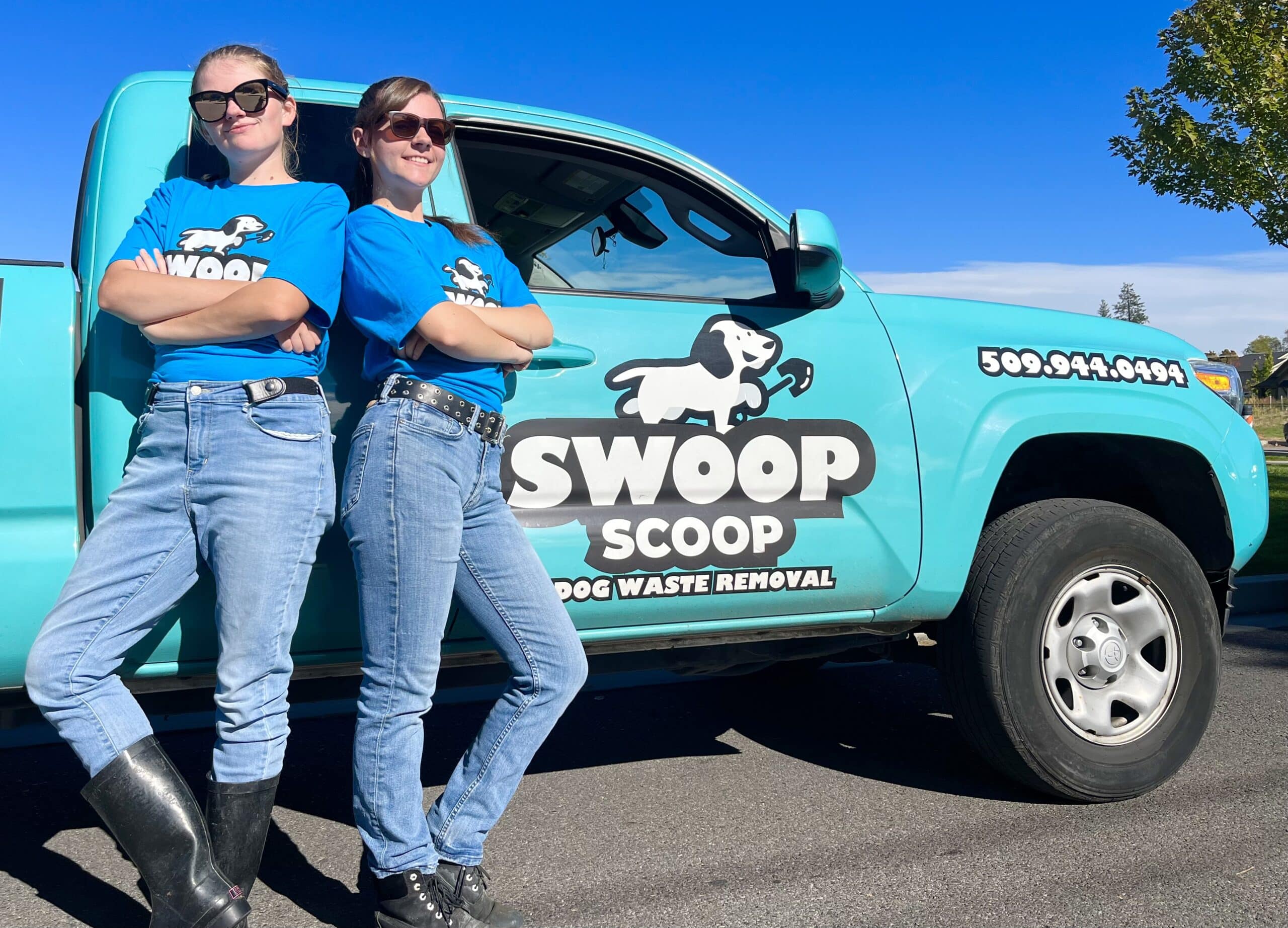 Pooper Scooper Team Members standing in front of a swoop scoop dog waste removal truck with sunglasses on.